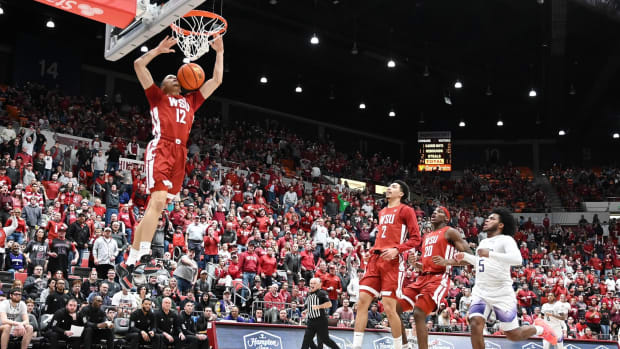 Isaiah Watts dunks on the Huskies in Thursday night's game.